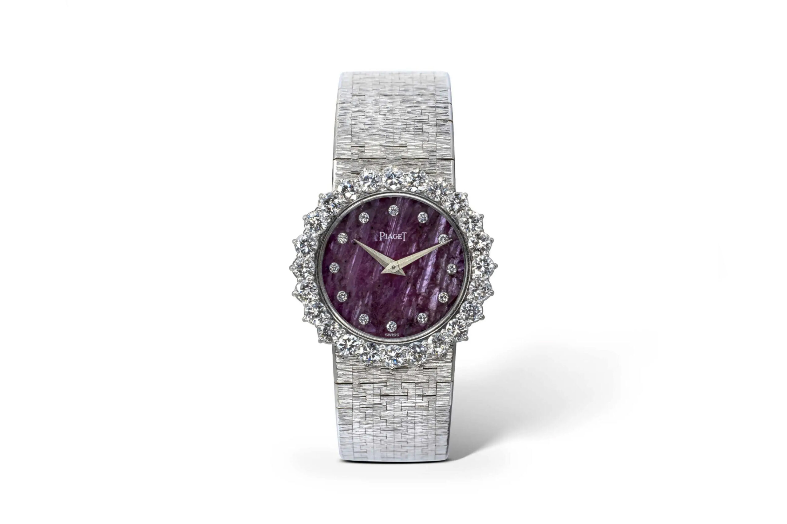 Luxurious timepiece adorned with rubies and diamonds.