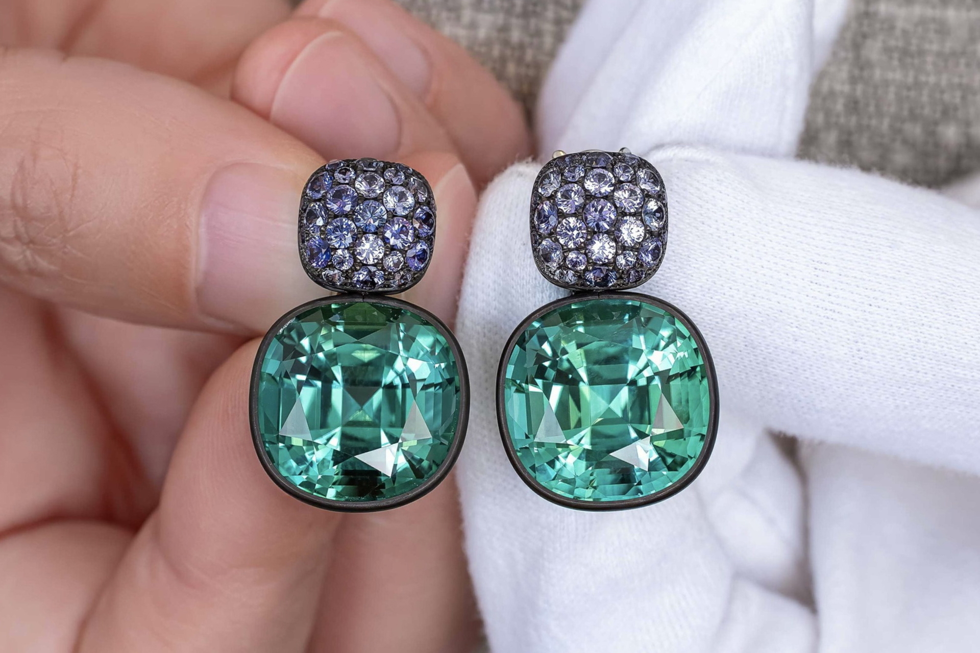 One-of-a-Kind Tourmaline and Sapphire Earrings in the hands