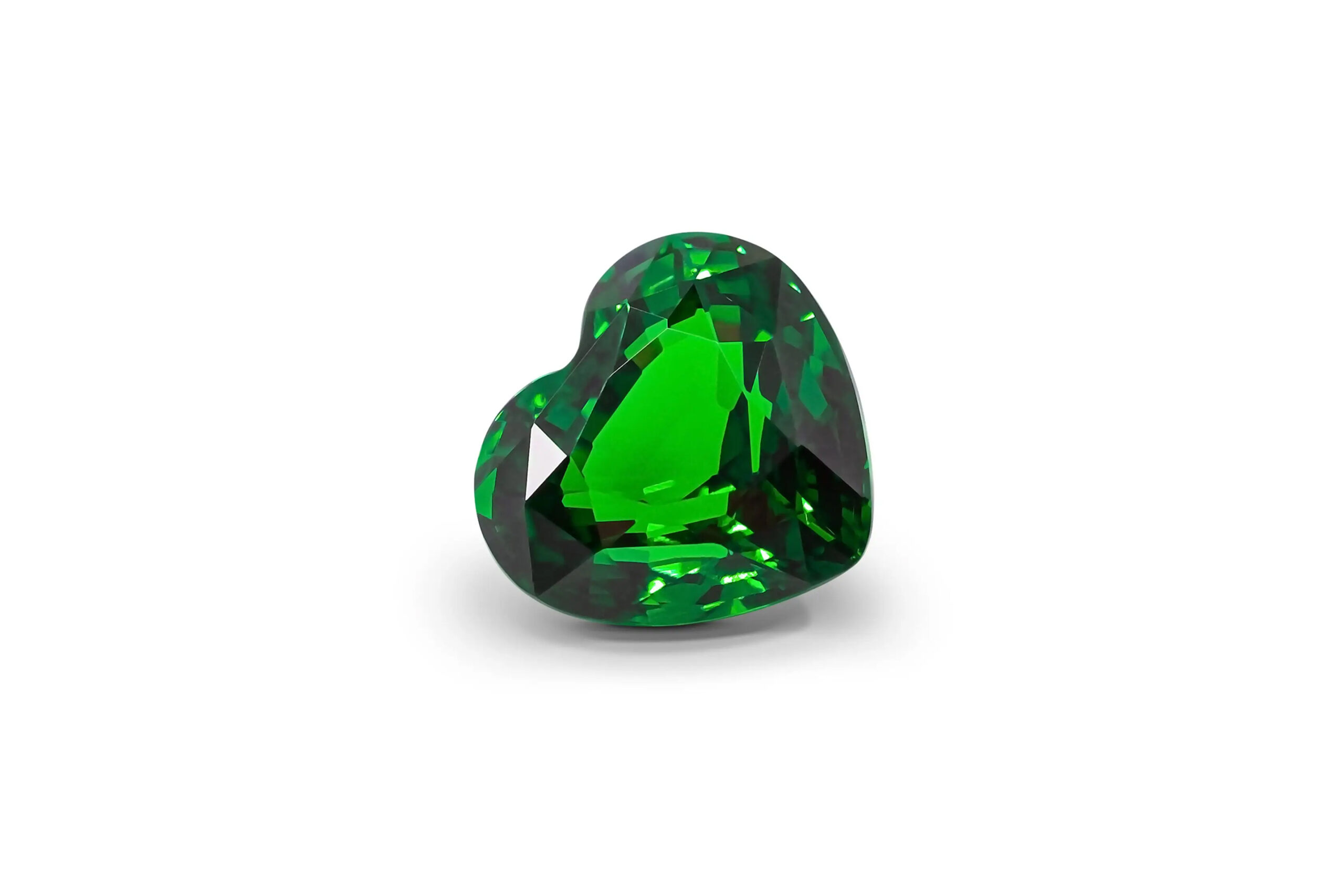 The tsavorite heart-shaped garnet on the white background