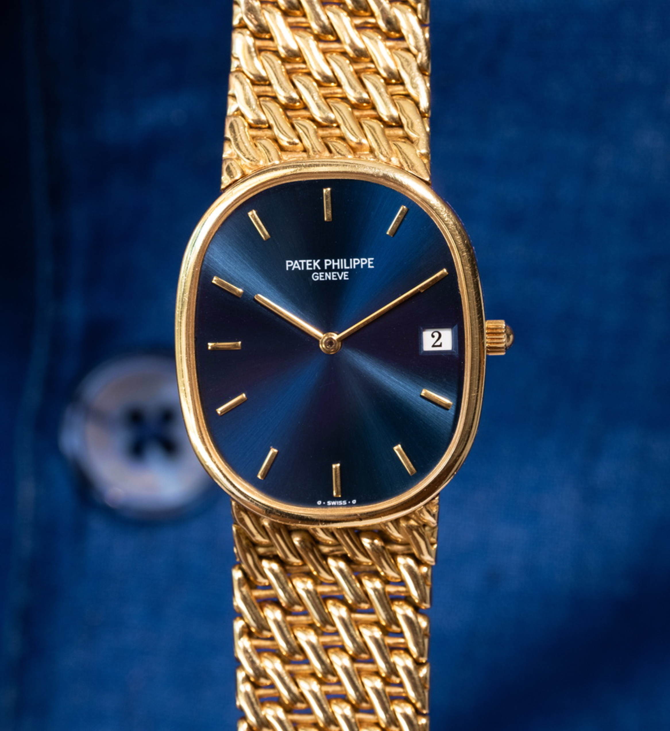 Patek Philippe in 18k Yellow Gold on the blue background