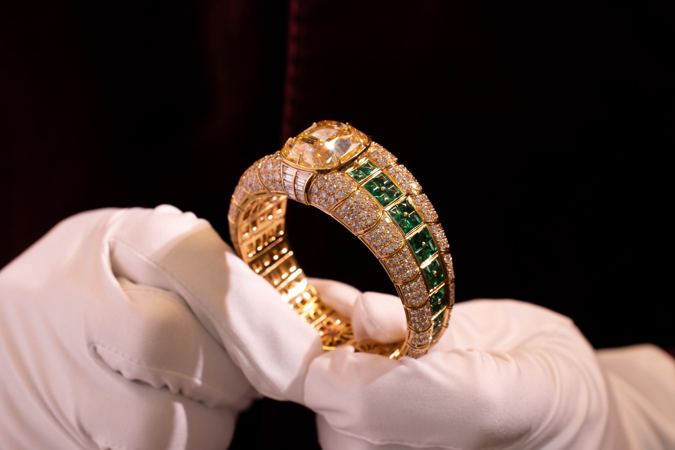 Bulgari Coloured Diamond and Emerald Bangle Bracelet in Hands in White Gloves
