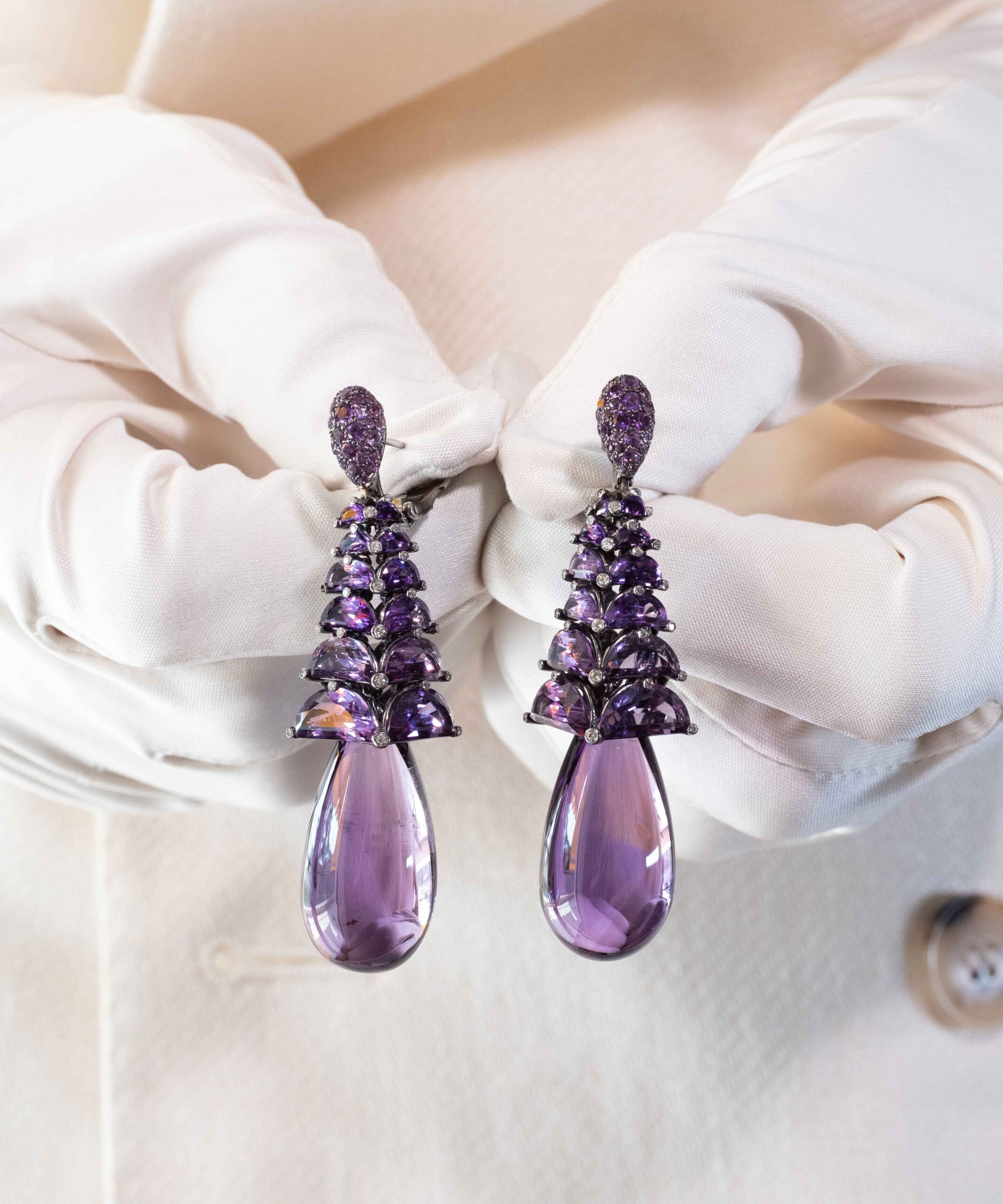 De Grisogono Amethyst Drop Earrings in the hands.
