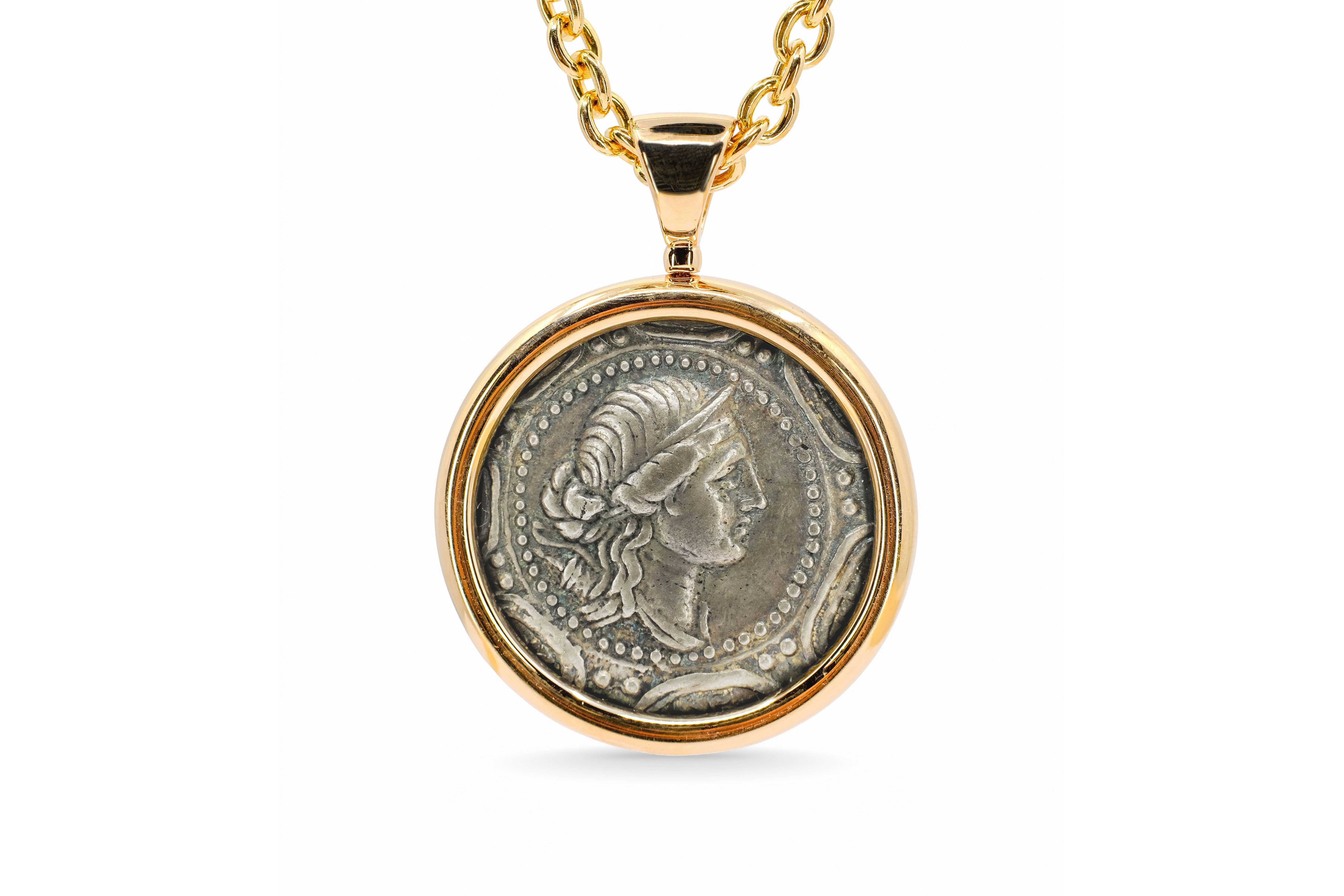 Bulgari Monete necklace: ancient Macedonian silver coin in a polished 18K gold bezel on a rolo-link chain